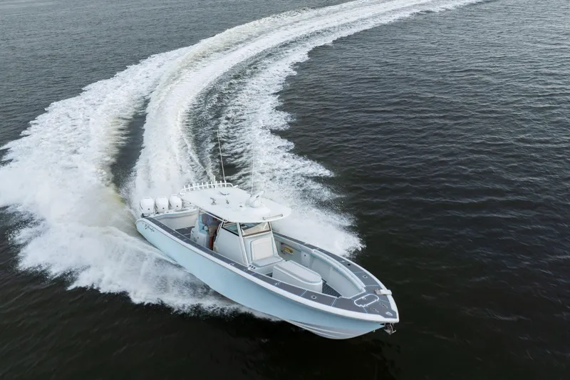 Slide: The Image of 2018 Yellowfin 39 Offshore boat making a sharp turn on open water. - 21