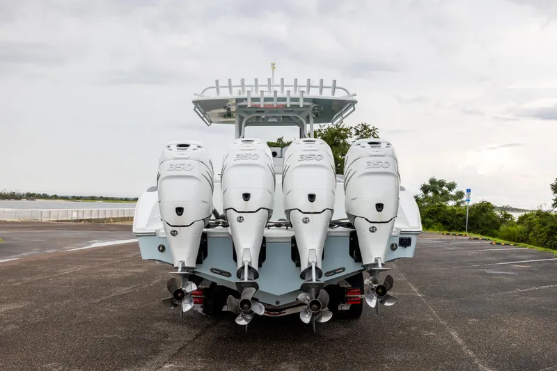 Slide: The Image of 2018 Yellowfin 39 Offshore boat with four powerful outboard engines, parked on a cloudy day. - 26