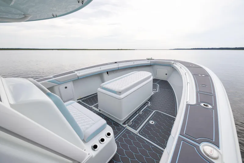 Slide: The Image of 2018 Yellowfin 39 Offshore boat interior with seating and storage on calm water. - 41