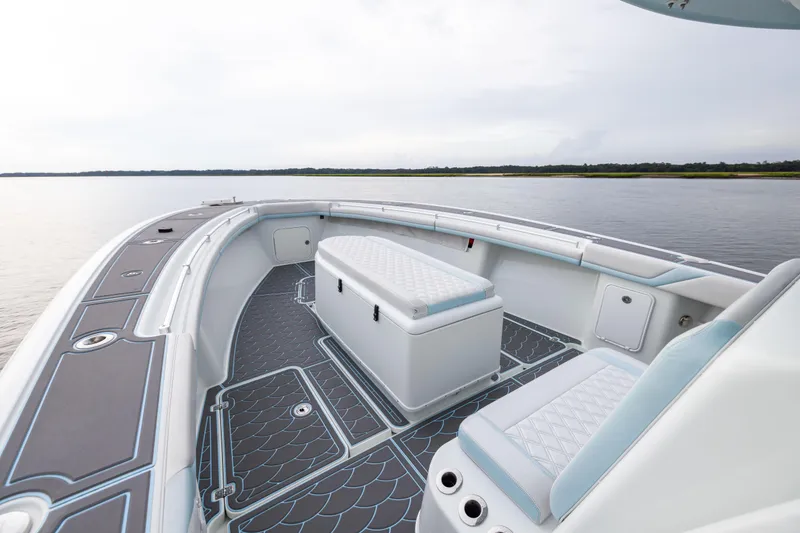 Slide: The Image of 2018 Yellowfin 39 Offshore boat interior with cushioned seating and scenic water view. - 42