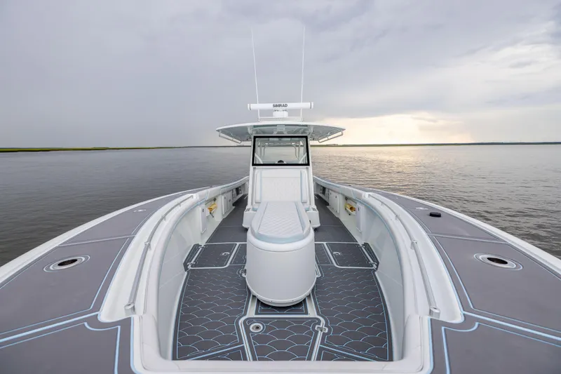 Slide: The Image of 2018 Yellowfin 39 Offshore boat on calm water under cloudy sky. - 46