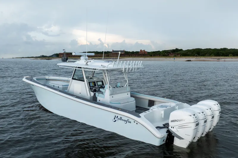 Slide: The Image of 2018 Yellowfin 39 Offshore boat with four Mercury engines on calm water near shore. - 5