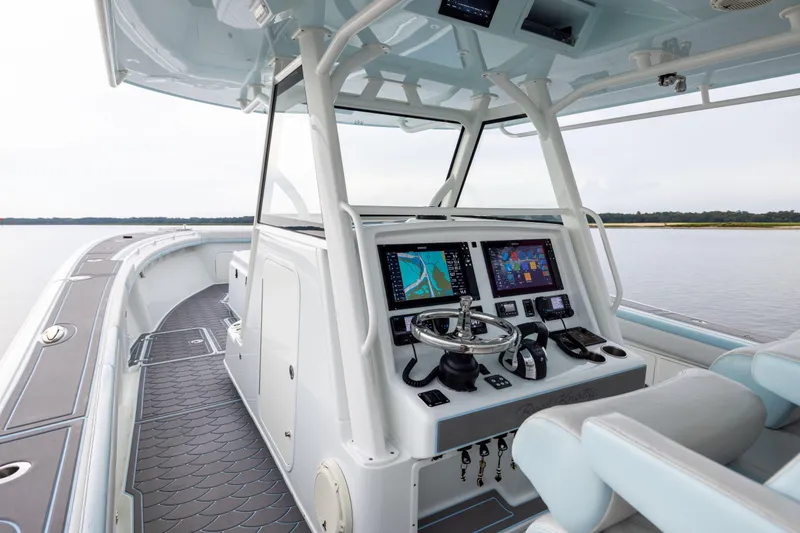Slide: The Image of 2018 Yellowfin 39 Offshore boat cockpit with advanced navigation systems and sleek design. - 51