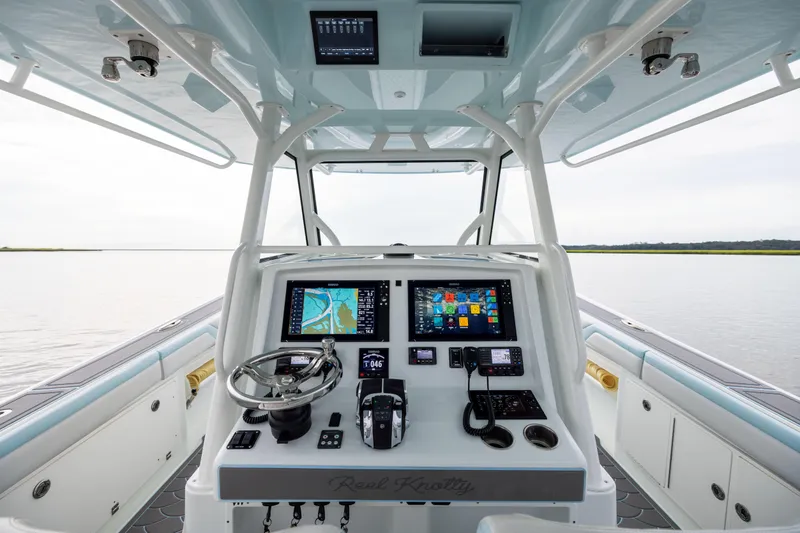 Slide: The Image of 2018 Yellowfin 39 Offshore boat cockpit with advanced navigation systems and steering wheel. - 53