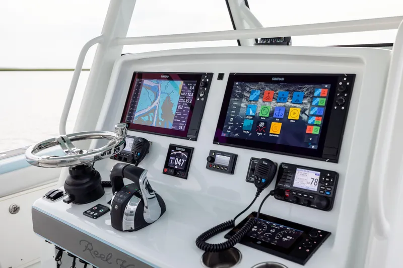 Slide: The Image of 2018 Yellowfin 39 Offshore boat dashboard with advanced navigation and control systems. - 55