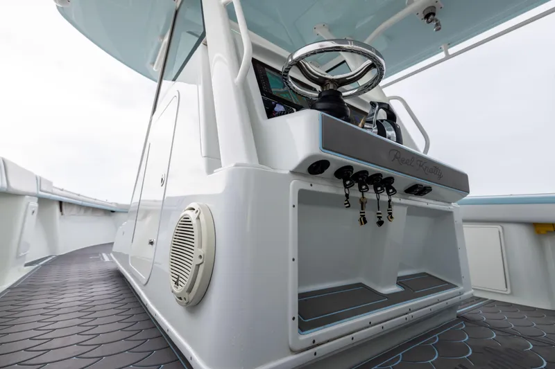 Slide: The Image of 2018 Yellowfin 39 Offshore boat helm with steering wheel and controls. - 57