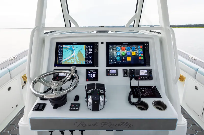 Slide: The Image of 2018 Yellowfin 39 Offshore boat dashboard with navigation screens and controls. - 60