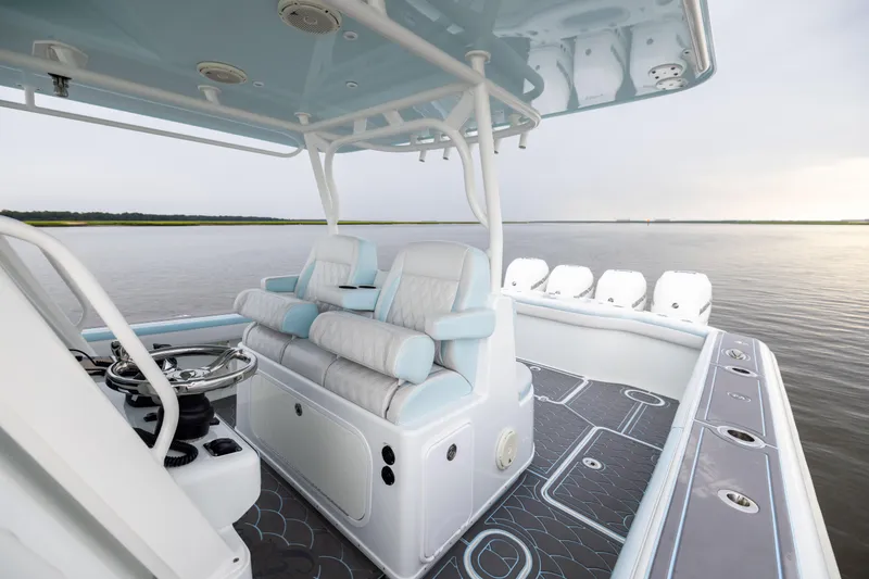 Slide: The Image of 2018 Yellowfin 39 Offshore boat interior with luxurious seating and modern design on calm water. - 63