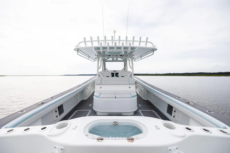 Slide: The Image of 2018 Yellowfin 39 Offshore boat interior with spacious deck and seating, on calm water. - 66