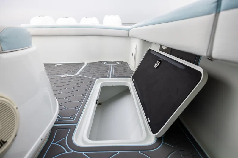 Slide: The Image of 2018 Yellowfin 39 Offshore boat interior with open storage compartment and cushioned seating. - 77