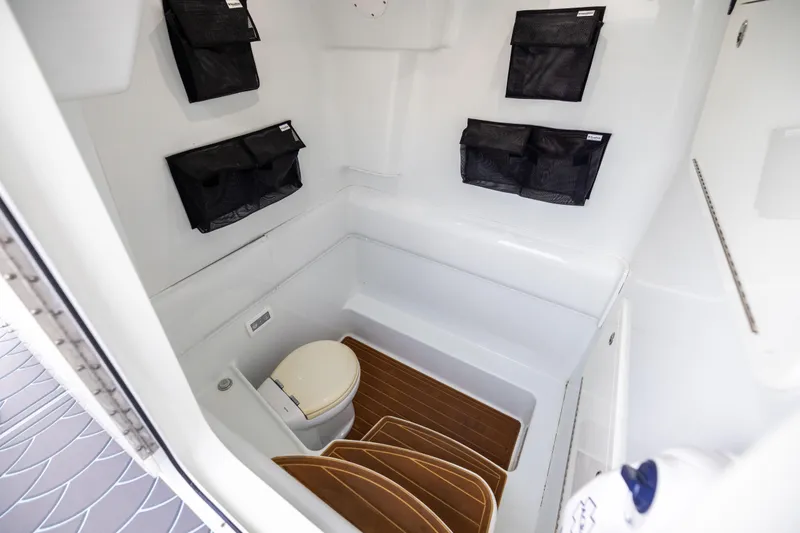 Slide: The Image of 2018 Yellowfin 39 Offshore boat interior with toilet and storage compartments. - 79