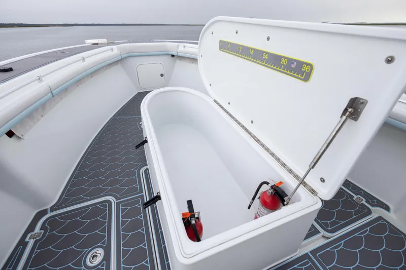 Slide: The Image of 2018 Yellowfin 39 Offshore boat with open storage compartment and fire extinguisher. - 81