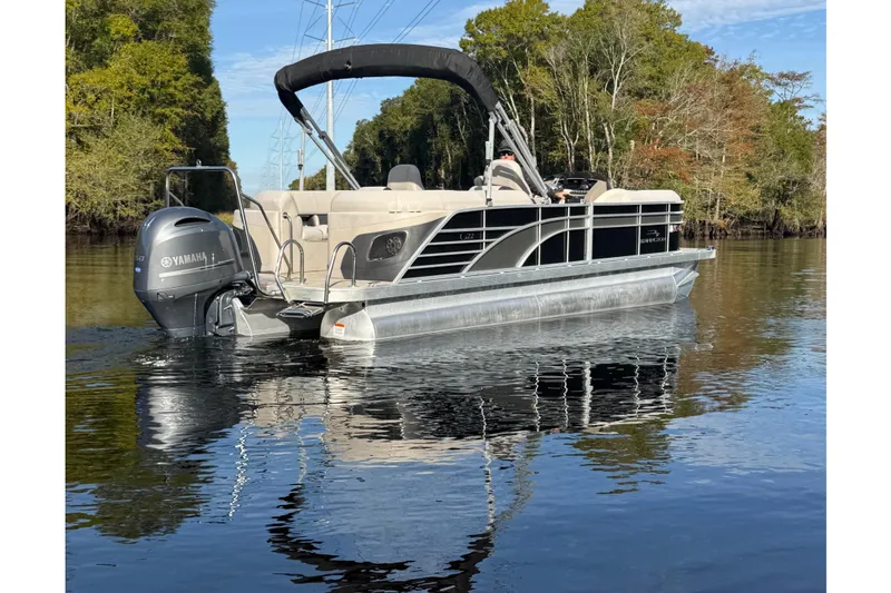 Slide: The Image of 2019 Bennington G 22 GSRFB pontoon boat on a calm river with Yamaha motor. - 3