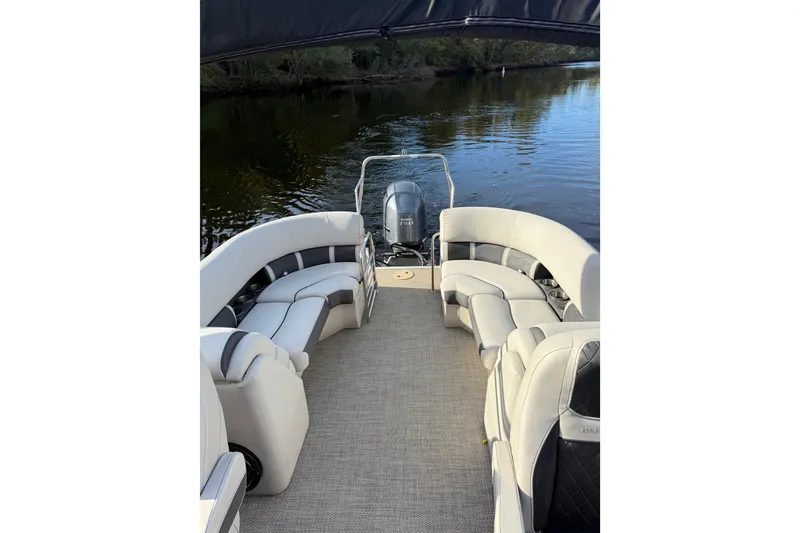 Slide: The Image of 2019 Bennington G 22 GSRFB pontoon boat with plush seating on a calm river. - 8