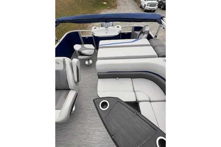 Slide: The Image of 2022 Bennington 22SXSAPG pontoon boat interior with gray seating and blue accents. - 10