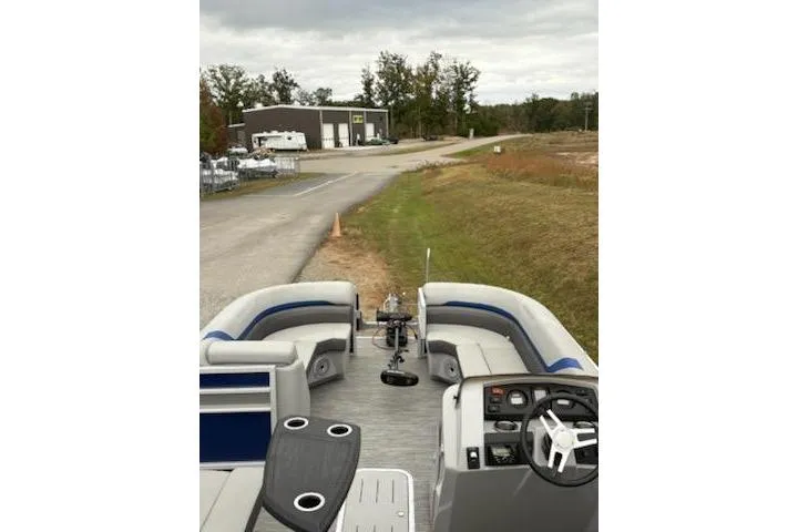 Slide: The Image of 2022 Bennington 22SXSAPG pontoon boat with spacious seating and modern controls. - 7