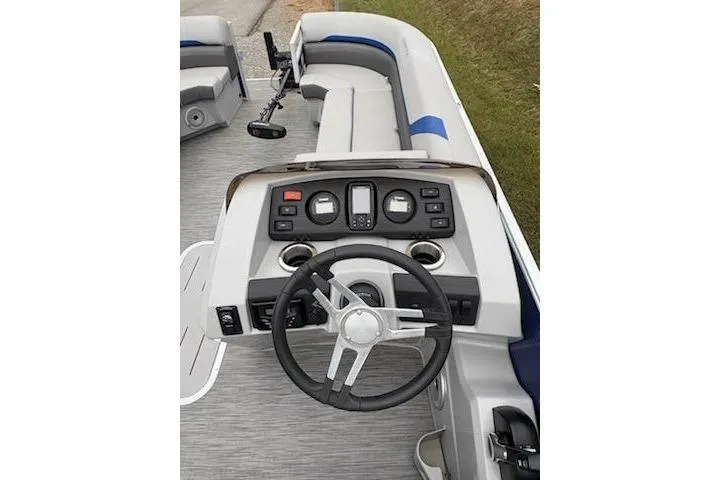 Slide: The Image of 2022 Bennington 22SXSAPG boat dashboard with steering wheel and control panel. - 9