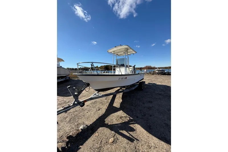 Slide: The Image of 2001 Maritime Skiff 18 on trailer under clear blue sky. - 1