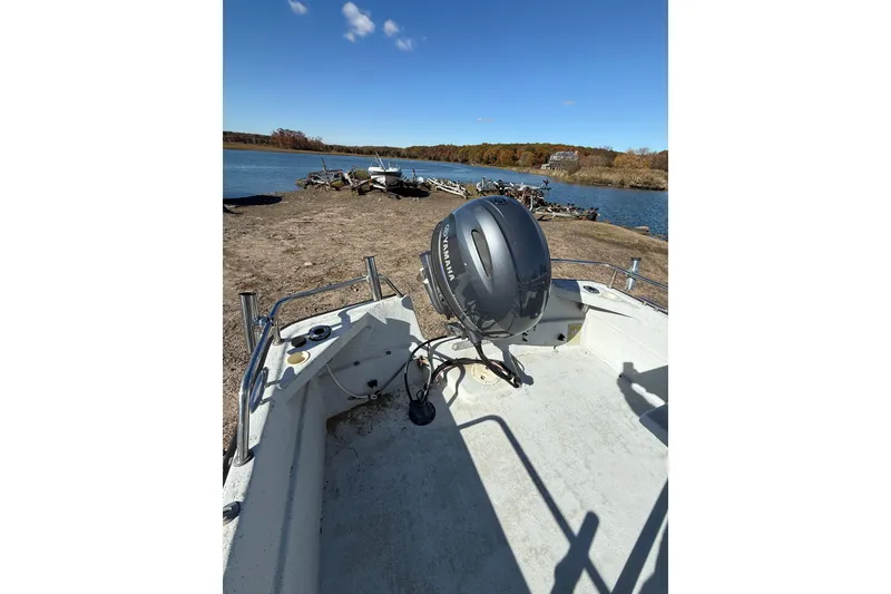 Slide: The Image of 2001 Maritime Skiff 18 boat with Yamaha motor by a scenic lake. - 7