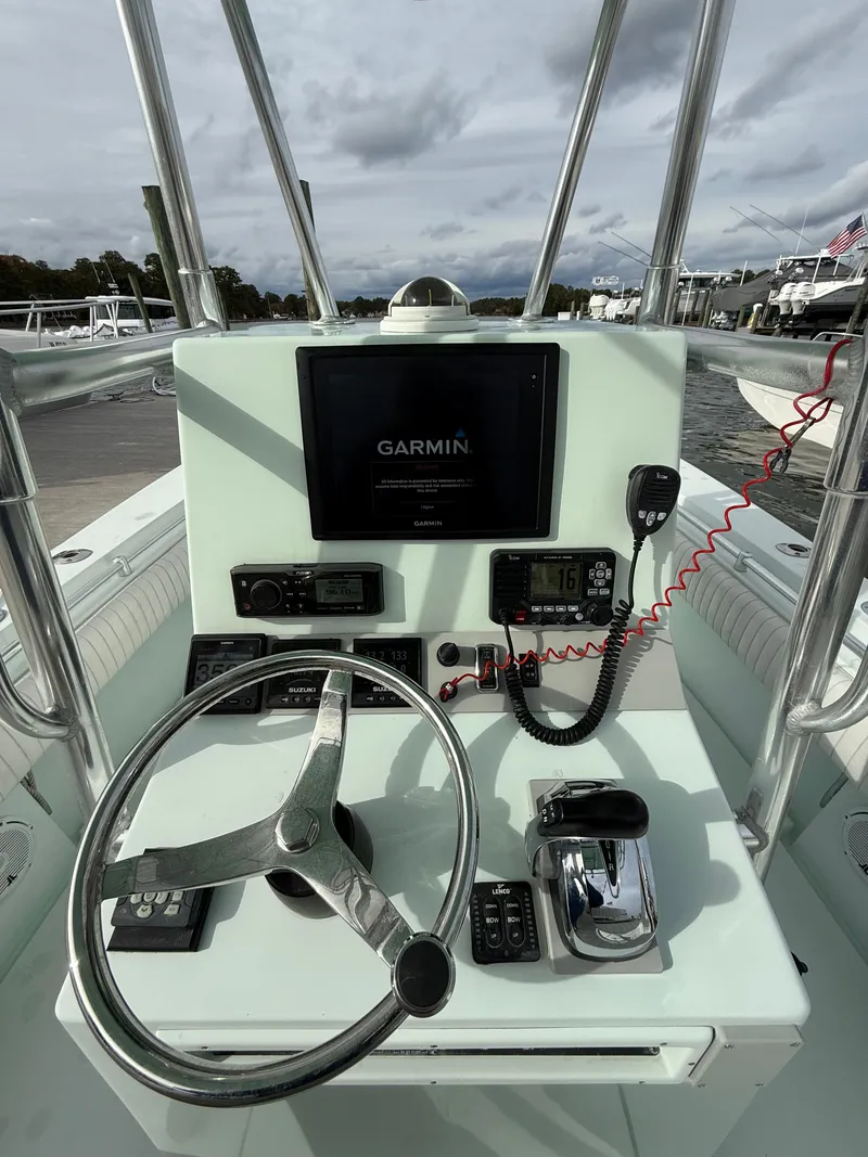 Slide: The Image of 2004 Contender 23 Tournament boat on trailer with Suzuki outboard motor. - 7