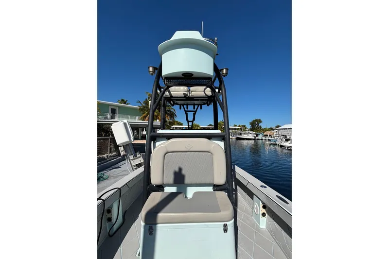 Slide: The Image of 2021 Xplor 24 Andros boat with seating, docked by a waterfront under clear blue skies. - 10