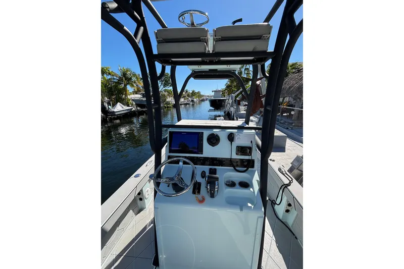 Slide: The Image of 2021 Xplor 24 Andros boat interior with steering wheel and control panel. - 12