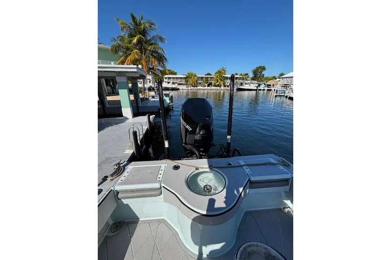 Slide: The Image of 2021 Xplor 24 Andros boat docked by waterfront with palm trees and clear blue sky. - 13