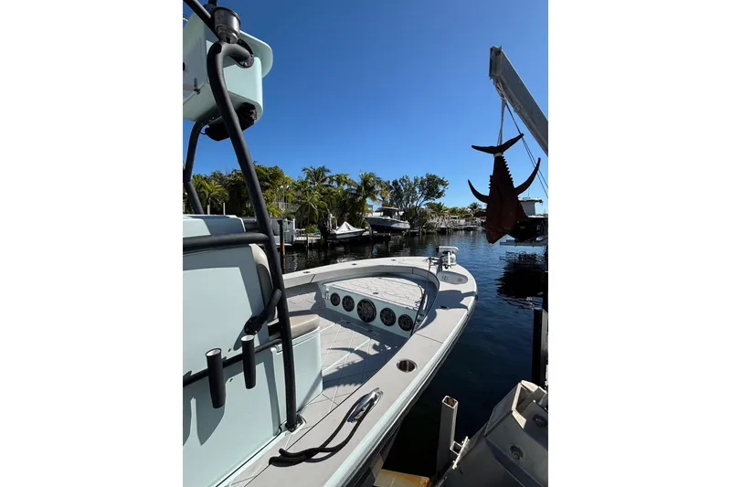 Slide: The Image of 2021 Xplor 24 Andros boat docked by water with hanging fish, sunny day. - 14
