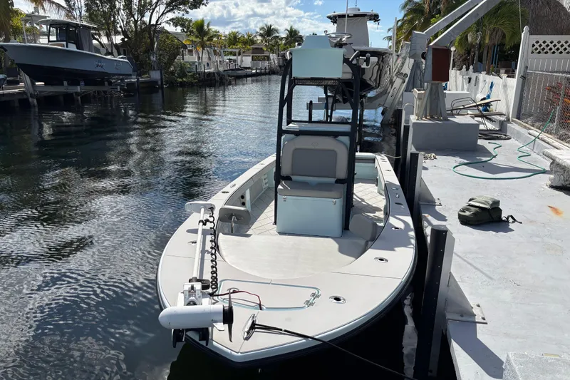Slide: The Image of 2021 Xplor 24 Andros boat docked by a canal under a sunny sky. - 18