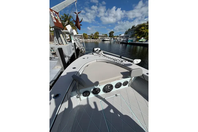 Slide: The Image of 2021 Xplor 24 Andros boat docked by a scenic waterfront under a clear blue sky. - 20