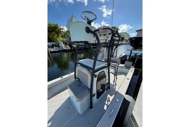 Slide: The Image of 2021 Xplor 24 Andros boat with elevated helm, docked by a serene waterfront. - 22