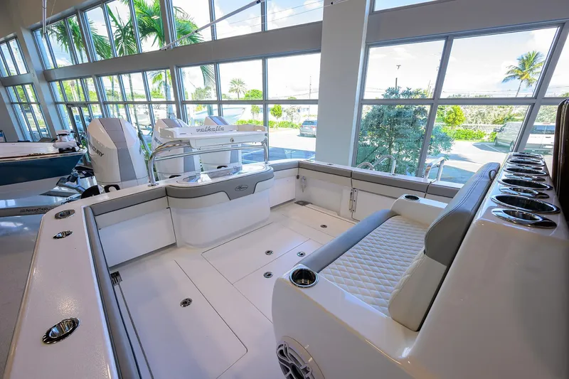 Slide: The Image of 2025 Valhalla V-37 boat interior with modern seating and sleek design in a showroom. - 18