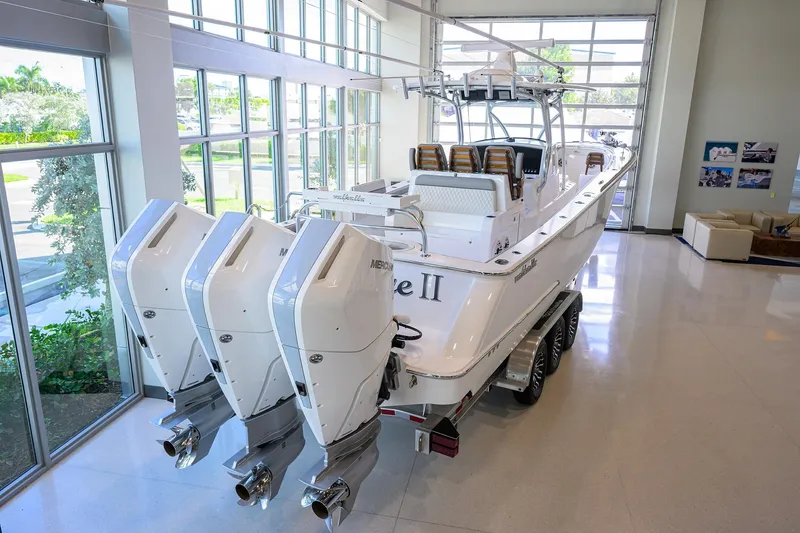 Slide: The Image of 2025 Valhalla V-37 boat with triple Mercury engines in a showroom setting. - 39