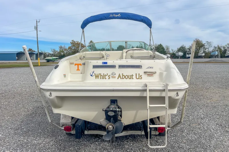 Slide: The Image of 1999 Sea Ray 215 Express Cruiser boat with custom name "Whit's About Us" on the stern. - 10