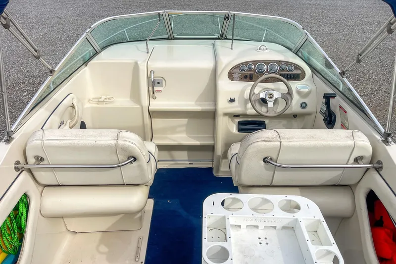 Slide: The Image of 1999 Sea Ray 215 Express Cruiser interior with steering wheel and seating. - 12