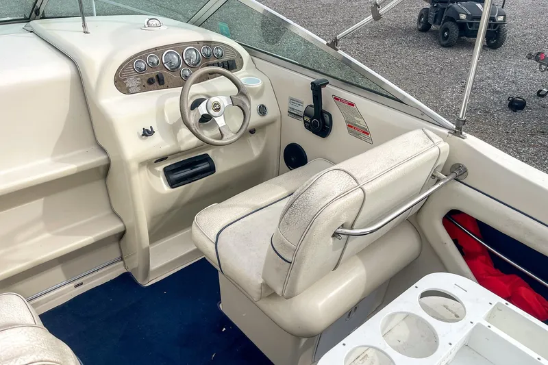 Slide: The Image of 1999 Sea Ray 215 Express Cruiser interior with steering wheel and dashboard controls. - 13