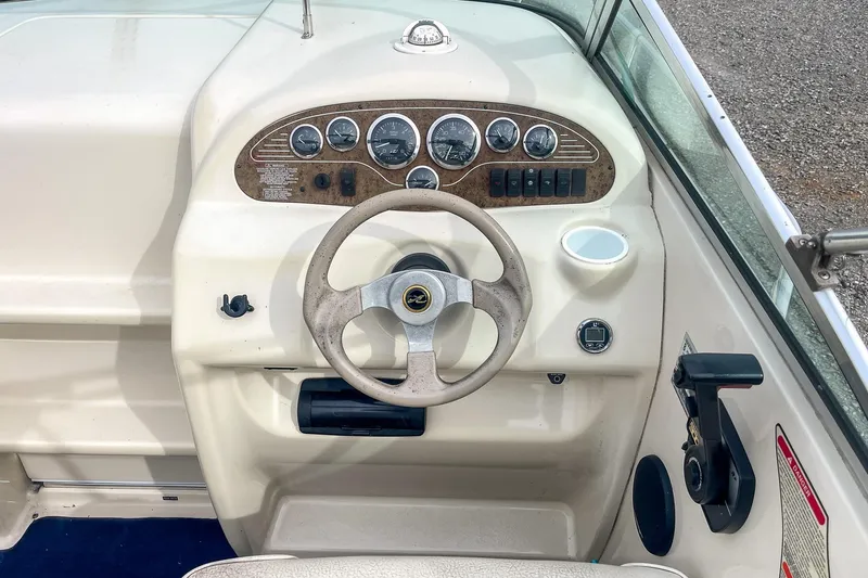 Slide: The Image of 1999 Sea Ray 215 Express Cruiser dashboard with steering wheel and instrument panel. - 15