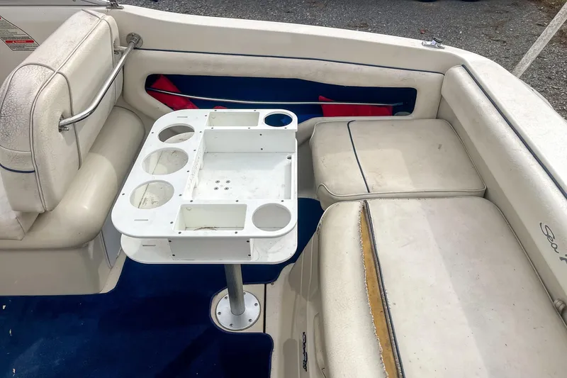 Slide: The Image of Interior of 1999 Sea Ray 215 Express Cruiser with seating and table setup. - 21