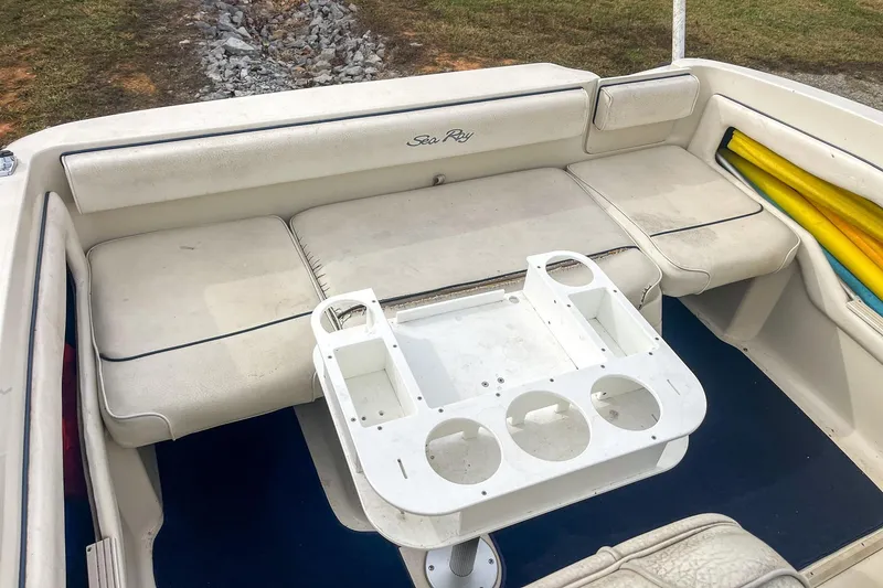 Slide: The Image of 1999 Sea Ray 215 Express Cruiser interior with seating and cup holder. - 22