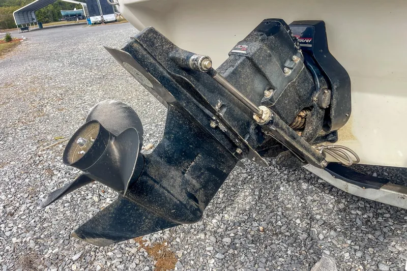 Slide: The Image of 1999 Sea Ray 215 Express Cruiser outboard motor on gravel surface. - 8