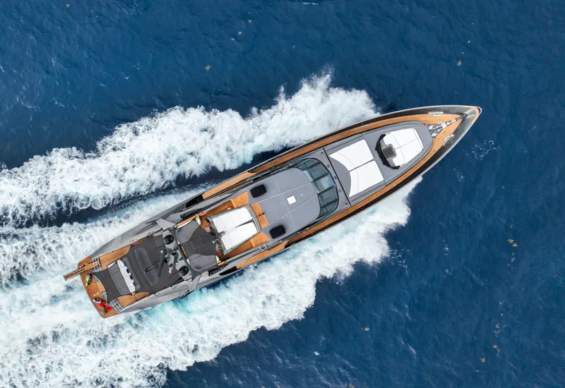 Slide: The Image of Aerial view of 2003 Palmer Johnson 120 yacht cruising on blue ocean waters. - 2
