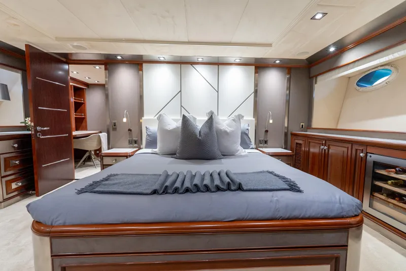 Slide: The Image of Luxurious bedroom interior on a 2003 Palmer Johnson 120 yacht, featuring elegant wood finishes. - 24