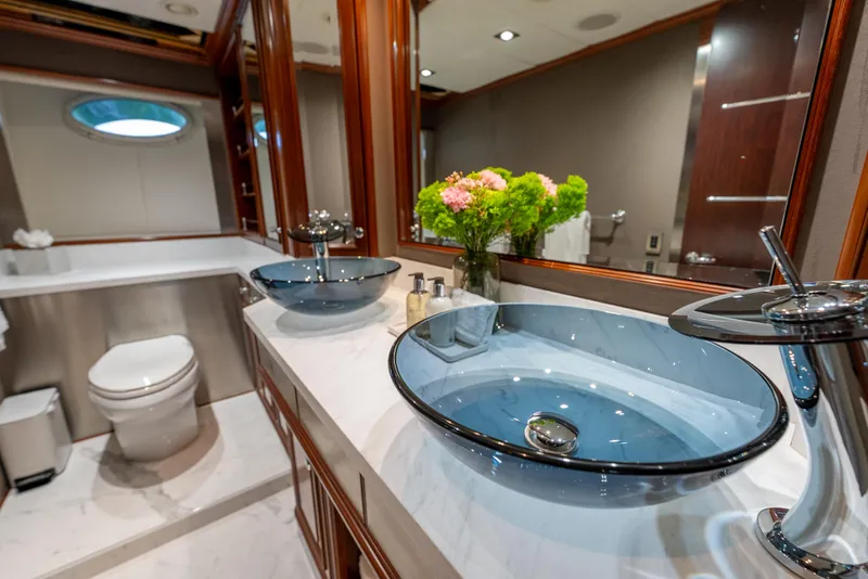 Slide: The Image of Luxurious yacht bathroom with dual glass sinks, elegant fixtures, and floral decor on Palmer Johnson 120. - 26