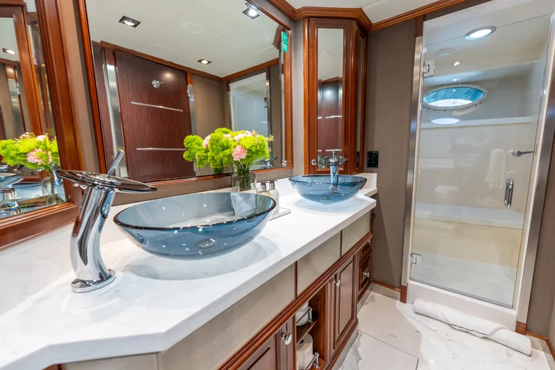 Slide: The Image of Luxurious yacht bathroom with dual glass sinks, elegant wood cabinetry, and modern fixtures. Palmer Johnson 120, 2003. - 27
