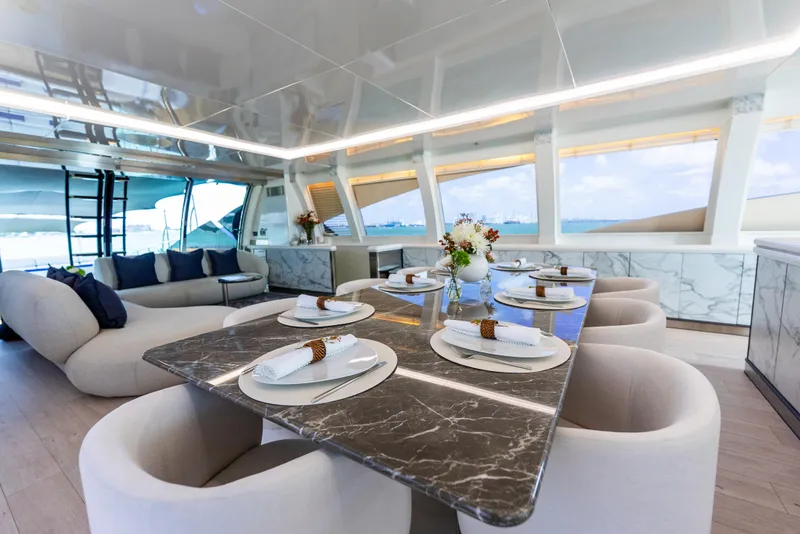 Slide: The Image of Luxurious interior of 2003 Palmer Johnson 120 yacht with elegant dining setup and modern decor. - 3
