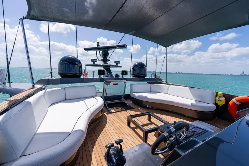 Slide: The Image of Luxurious Palmer Johnson 120 yacht deck with seating, ocean view, and clear skies, 2003 model. - 36