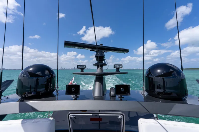 Slide: The Image of Palmer Johnson 120 yacht bridge view, 2003 model, navigating turquoise waters under blue sky. - 38