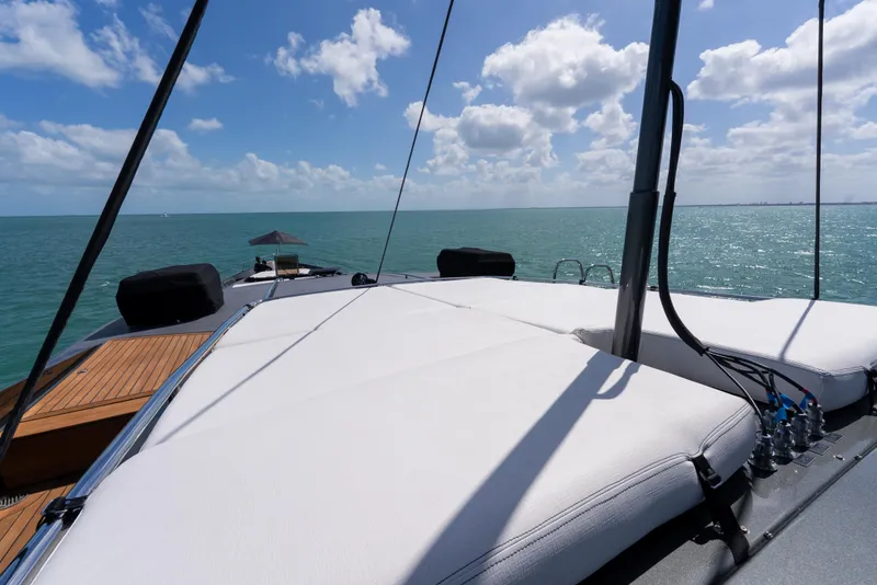 Slide: The Image of Luxurious Palmer Johnson 120 yacht deck with sunbathing area, ocean view, and clear blue sky. - 40