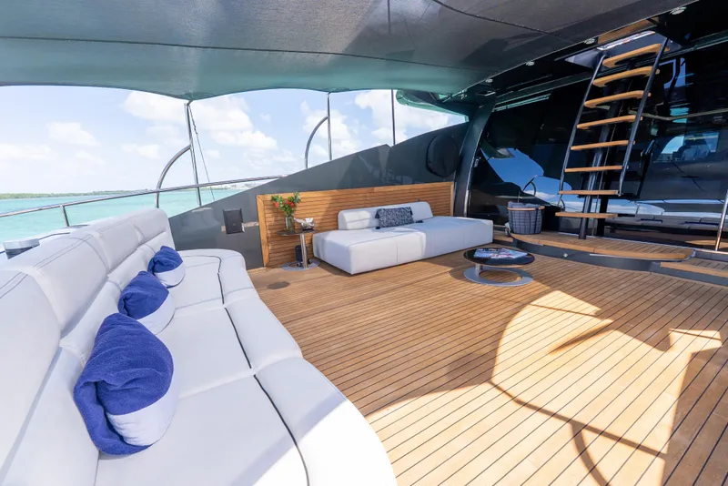 Slide: The Image of Luxurious Palmer Johnson 120 yacht deck with elegant seating, wooden flooring, and ocean view. - 41