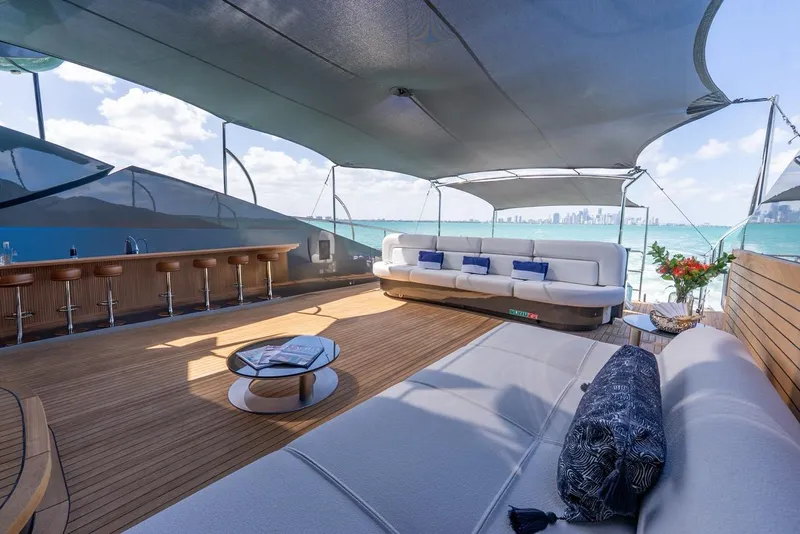 Slide: The Image of Luxurious Palmer Johnson 120 yacht deck with elegant seating, bar, and ocean view, 2003 model. - 42